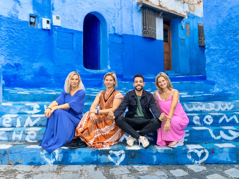 Travelers with their guide in Chefchaouen on a 15-day Morocco tour from Casablanca